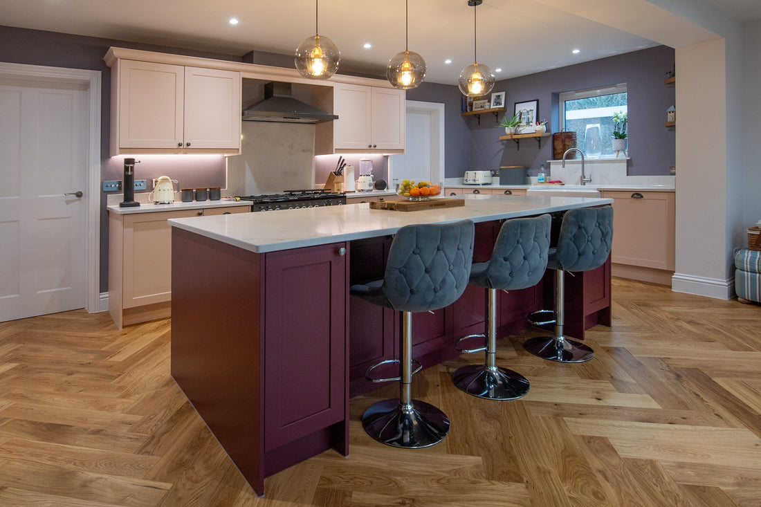 a two-tone pink shaker kitchen with white quartz worktops